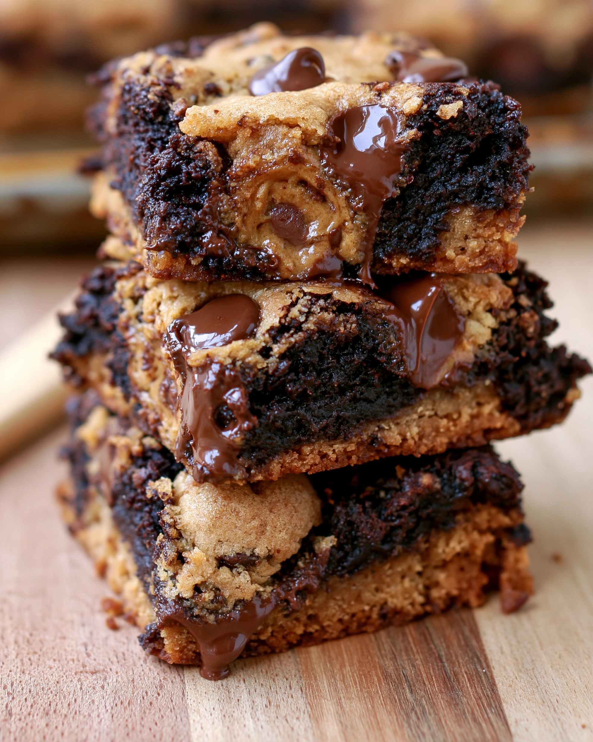 Easy brookies cookie brownies recipe — thick stacked bars with chocolate chip cookie and fudgy brownie layers and melted chocolate dripping down the sides